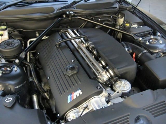 BMW M inline-six engine with exposed intake runners in the engine bay
